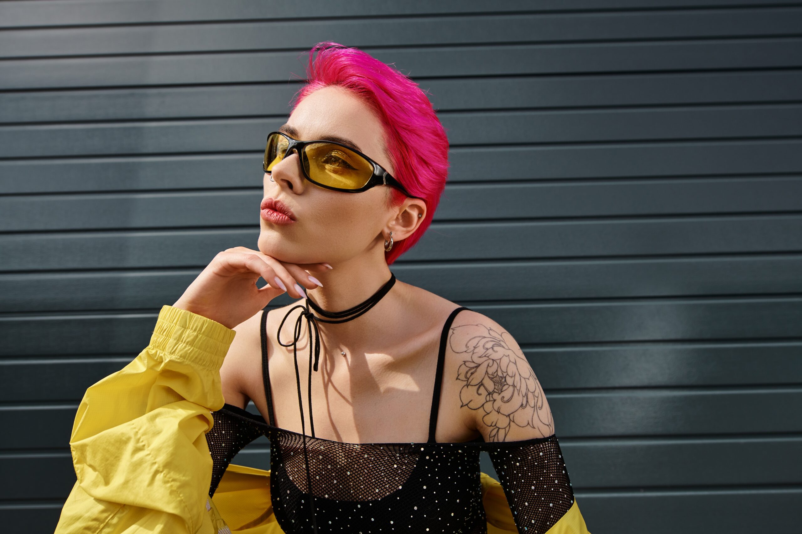 Pensive,Young,Woman,With,Pink,Hair,And,Tattoo,Posing,In